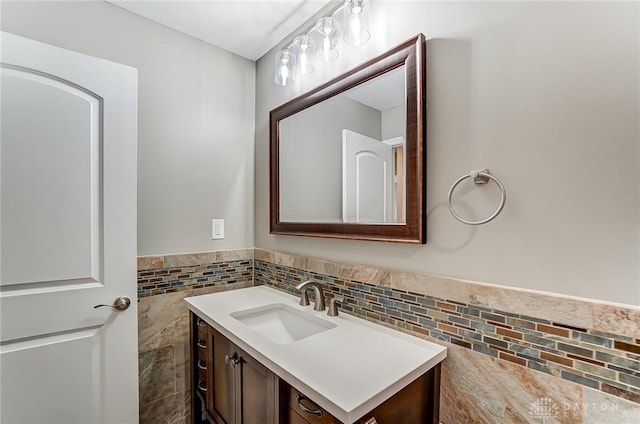 bathroom with tile walls, wainscoting, and vanity