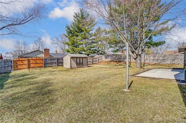 view of yard featuring a patio area, a fenced backyard, a storage unit, and an outdoor structure