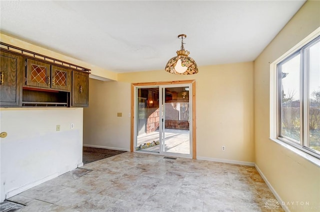 unfurnished dining area with visible vents and baseboards