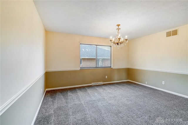 spare room featuring visible vents, carpet floors, and baseboards