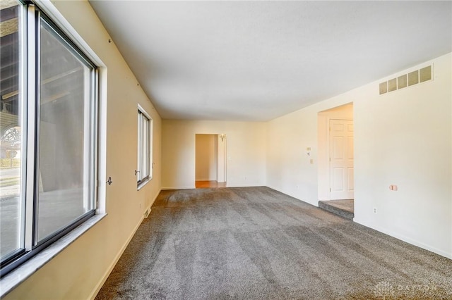 unfurnished room with carpet flooring and visible vents