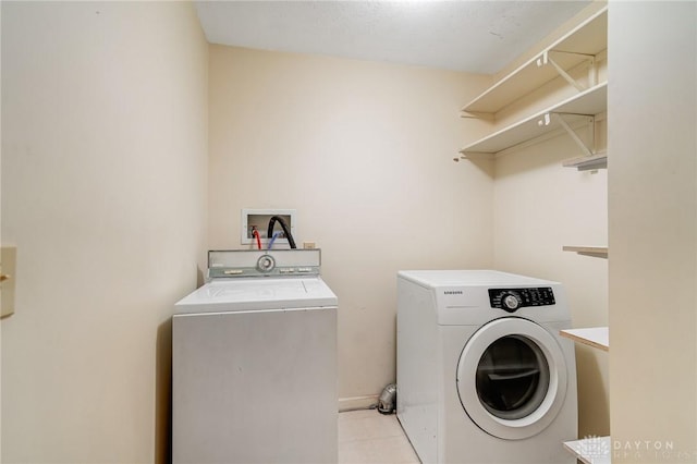 laundry room featuring washer and dryer, laundry area, and light tile patterned floors