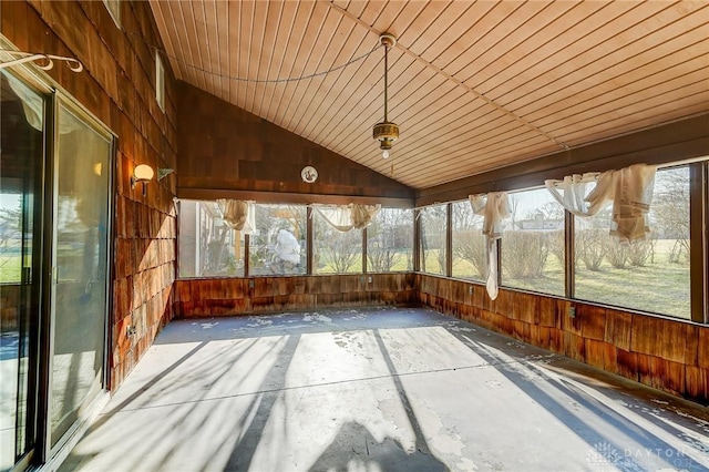 unfurnished sunroom featuring vaulted ceiling