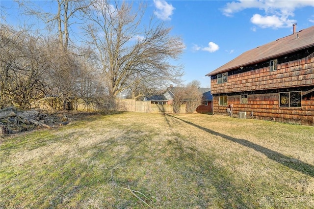 view of yard featuring cooling unit and fence