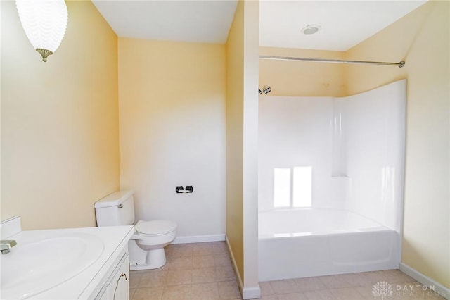 bathroom with bathtub / shower combination, toilet, vanity, and baseboards