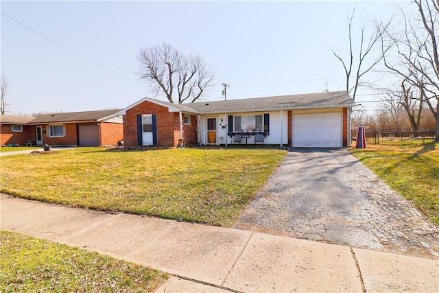 single story home featuring aphalt driveway, fence, a front yard, a garage, and brick siding