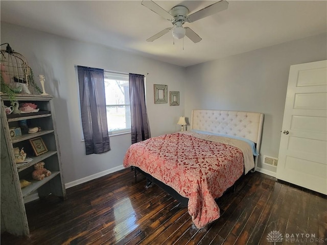 bedroom with visible vents, baseboards, ceiling fan, and hardwood / wood-style flooring