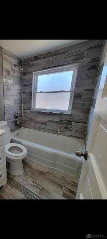 bathroom featuring shower / washtub combination, vanity, toilet, and wood finished floors