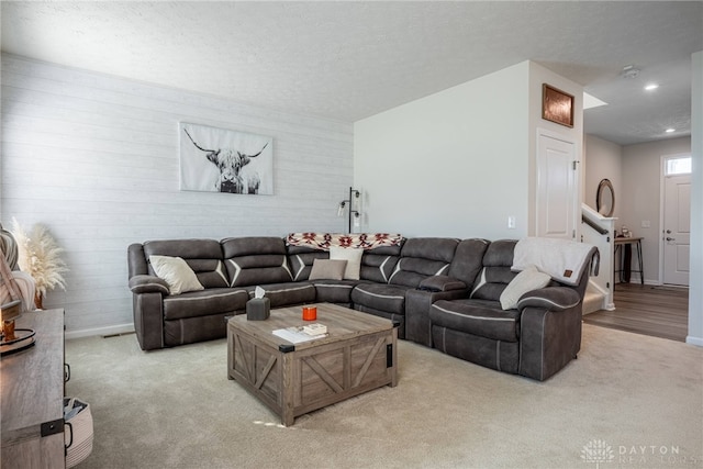 living area with recessed lighting, baseboards, carpet floors, and a textured ceiling