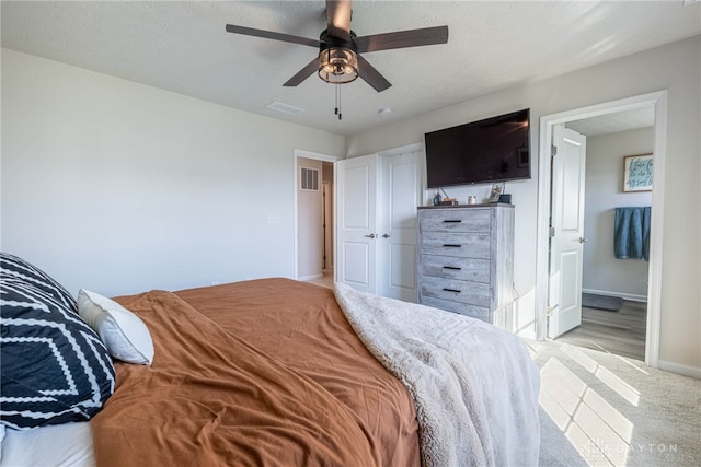 bedroom with light carpet, visible vents, ceiling fan, and baseboards