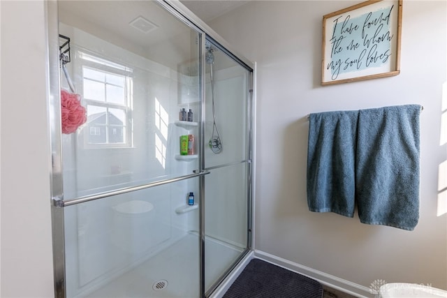 bathroom featuring a shower stall and visible vents