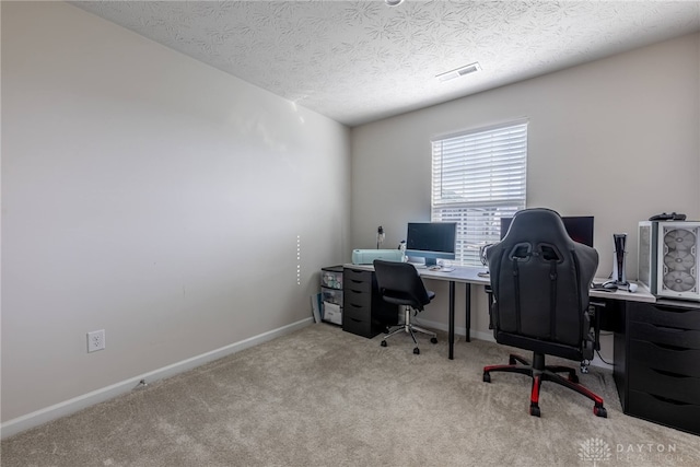 office space featuring visible vents, baseboards, carpet, and a textured ceiling