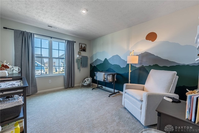 living area with carpet flooring, visible vents, a textured ceiling, and baseboards