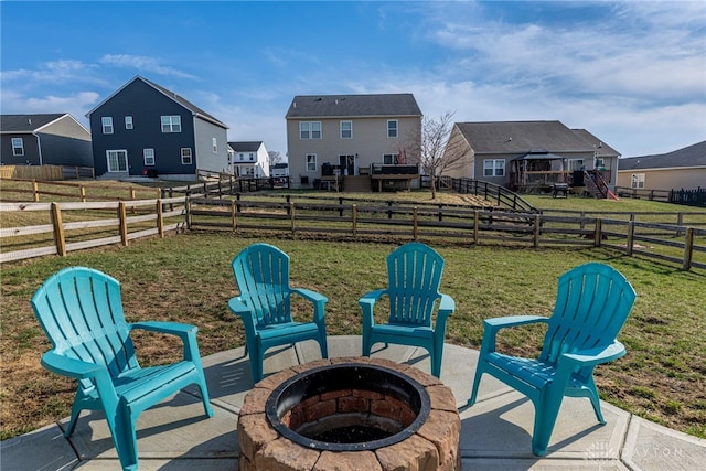 view of yard featuring a rural view, a patio, a fire pit, and fence