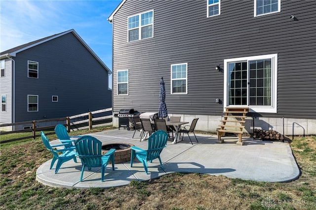 rear view of house with a fire pit, fence, a patio, and entry steps