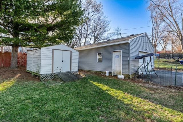 view of outdoor structure featuring driveway, an outdoor structure, and fence