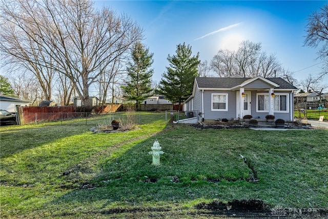 view of front of house with a front yard and fence