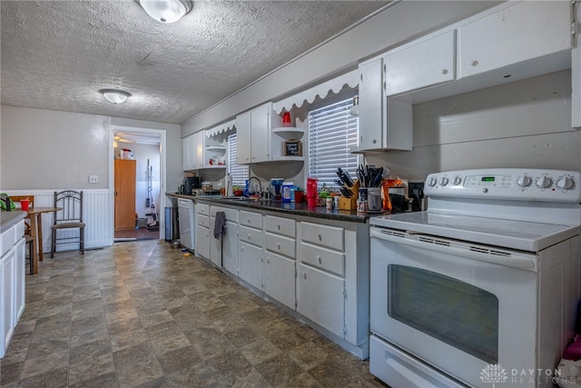 kitchen with a wainscoted wall, open shelves, dark countertops, white appliances, and white cabinets