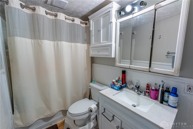 full bath featuring visible vents, toilet, a textured ceiling, shower / bath combination with curtain, and vanity