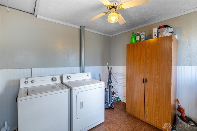 laundry room featuring washer and clothes dryer, a textured ceiling, wood finished floors, wainscoting, and laundry area