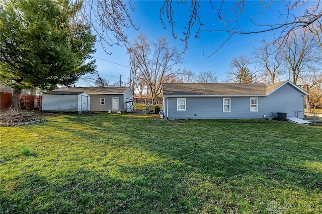 back of house with fence, a shed, central air condition unit, an outdoor structure, and a yard