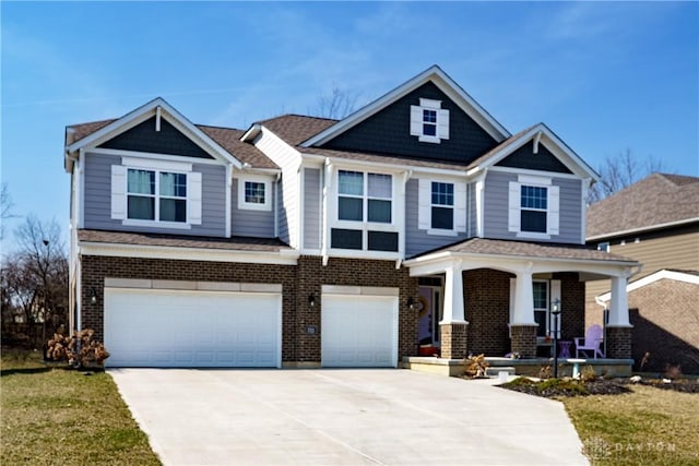 craftsman-style house with an attached garage, brick siding, covered porch, and driveway