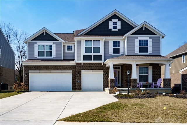 craftsman house featuring a garage, brick siding, a porch, and concrete driveway