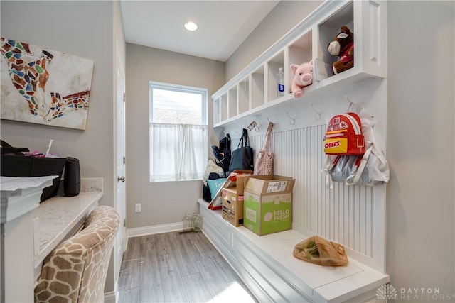 mudroom with baseboards and wood finished floors