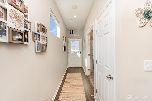 entryway featuring baseboards and wood finished floors