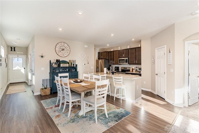 dining area featuring recessed lighting, wood finished floors, and baseboards