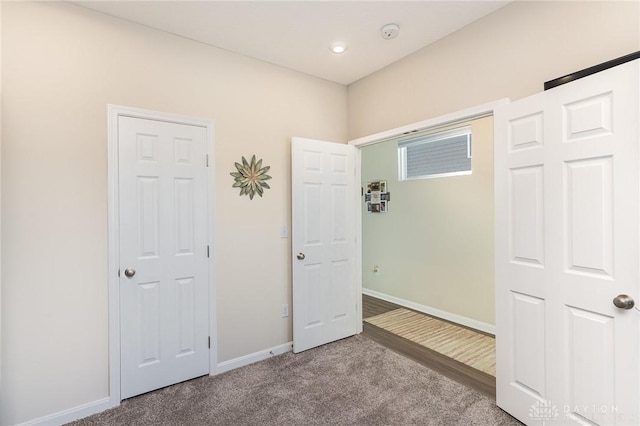 unfurnished bedroom featuring baseboards and carpet