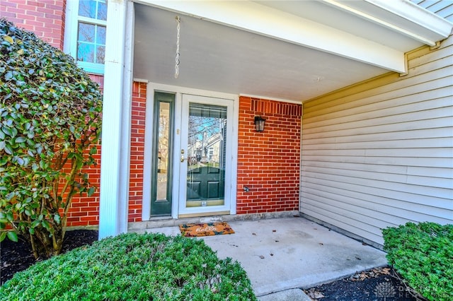 property entrance with brick siding