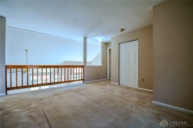 spare room with carpet flooring and baseboards