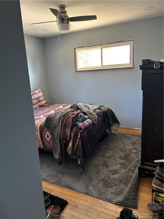 bedroom featuring ceiling fan and wood-type flooring