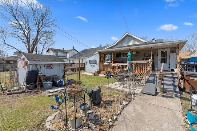 rear view of house with a yard, a shed, a patio area, and an outdoor structure