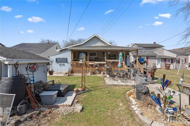 back of property featuring a yard and a patio area