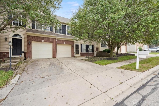 view of front of property featuring a garage, brick siding, and driveway