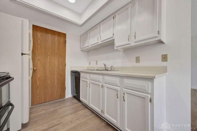 kitchen featuring a sink, black dishwasher, white cabinets, light wood finished floors, and light countertops