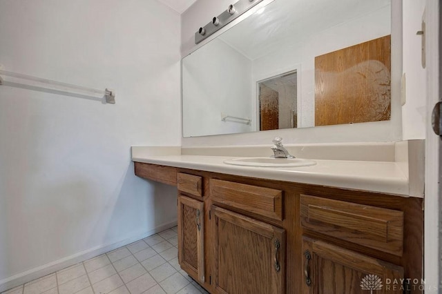 bathroom featuring tile patterned flooring, vanity, and baseboards