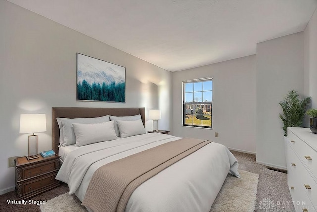 bedroom with baseboards and light carpet