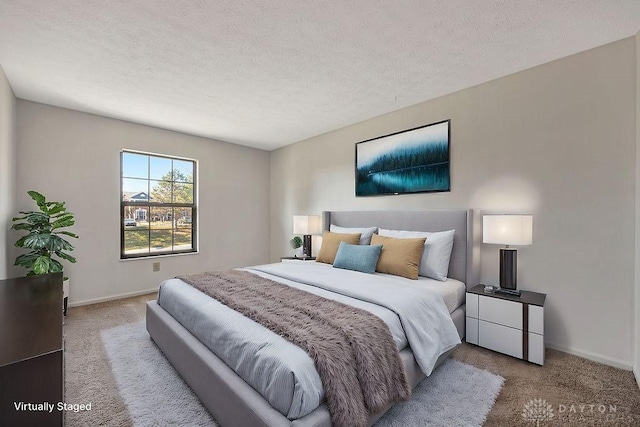 bedroom featuring baseboards, a textured ceiling, and carpet flooring