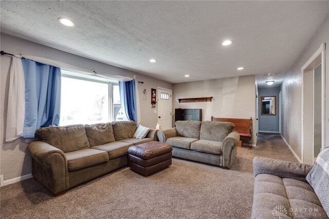 carpeted living room featuring recessed lighting, a textured ceiling, and baseboards