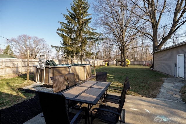 view of patio / terrace with outdoor dining space, a fenced in pool, and a fenced backyard