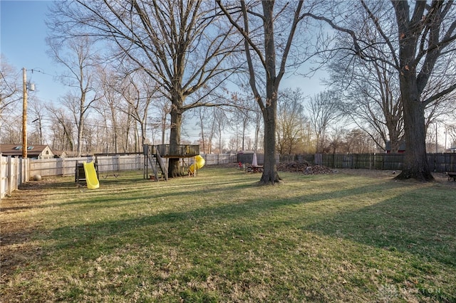 view of yard with a playground and a fenced backyard