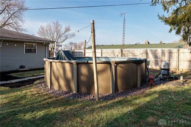 view of swimming pool with a fenced in pool, a lawn, and a fenced backyard