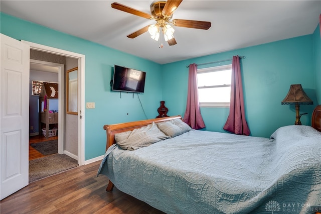 bedroom with baseboards, wood finished floors, and a ceiling fan