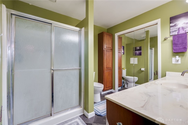 full bathroom featuring tile patterned floors, vanity, toilet, and a shower stall