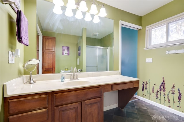 bathroom featuring tile patterned floors, baseboards, vanity, and a shower stall