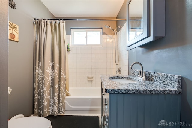 full bathroom featuring shower / tub combo with curtain, toilet, and vanity