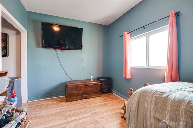 bedroom with wood finished floors and baseboards